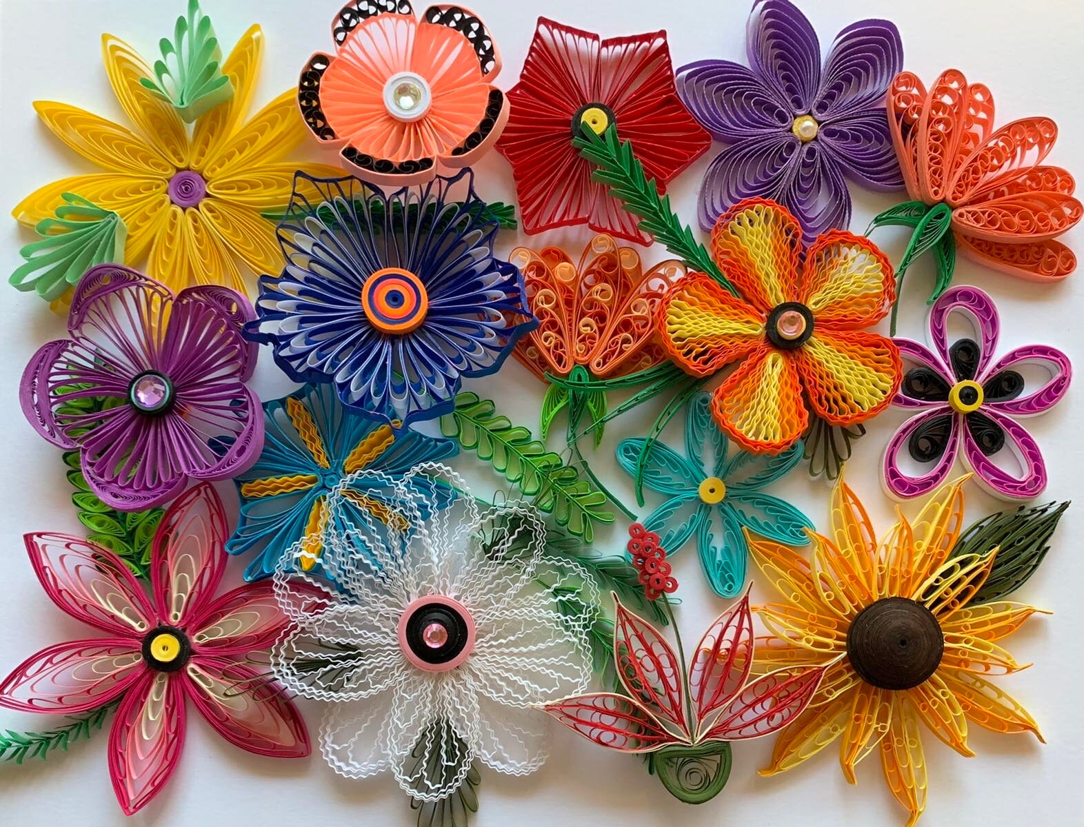 flowers made using quilling comb. quilled paper flowers. quilled flowers using quilling comb. crimped paper flowers. colorful quilled flower. quilled paper art.
