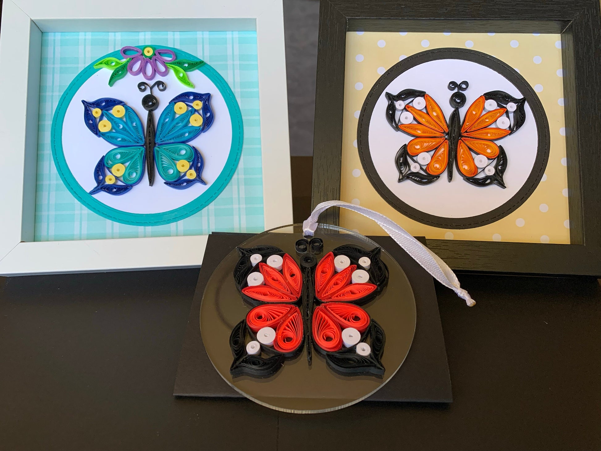 Three quilled butterflies in frames.