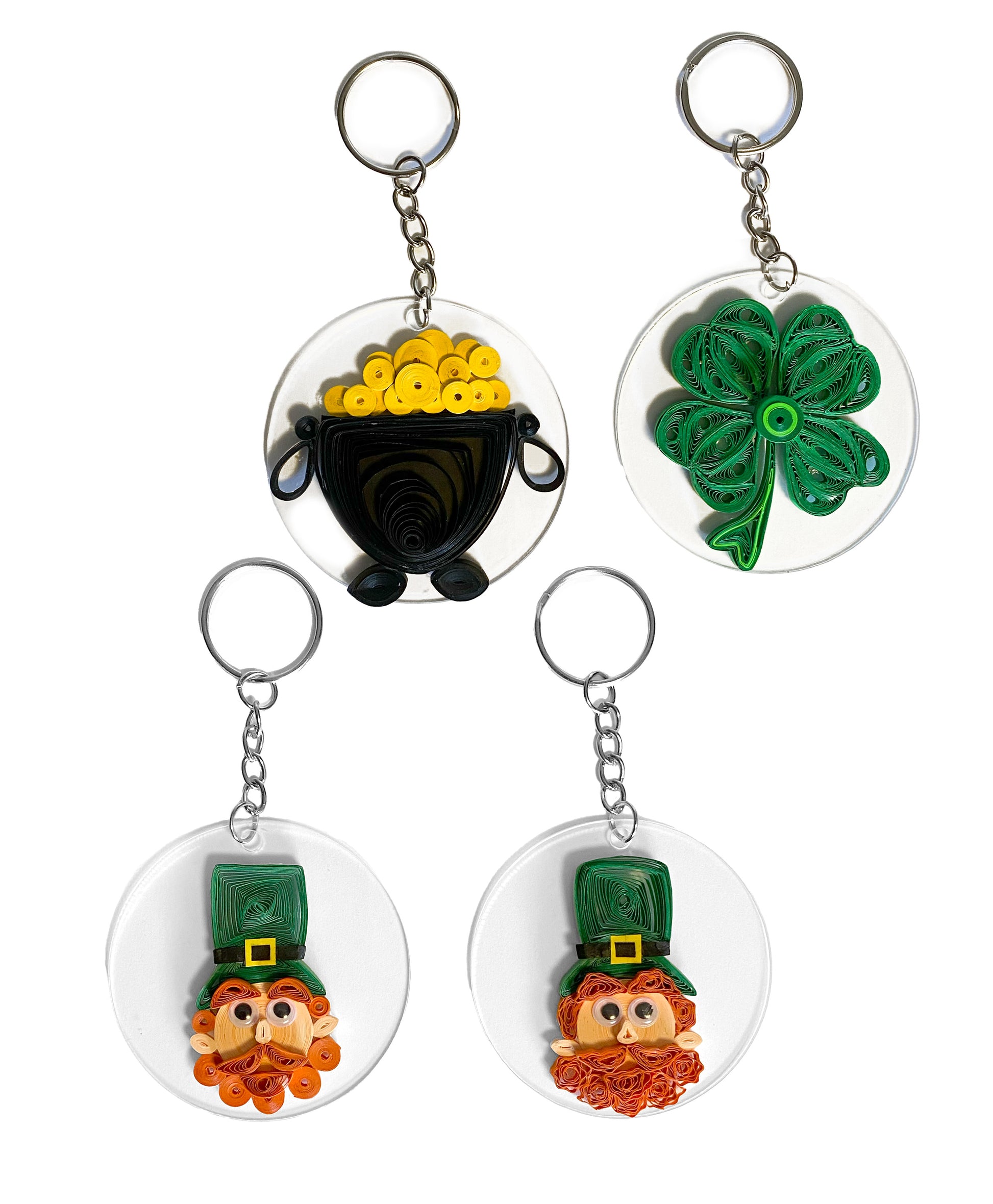 Quilled key chains on white background. Pot of gold, four leaf clover, and two leprechauns.
