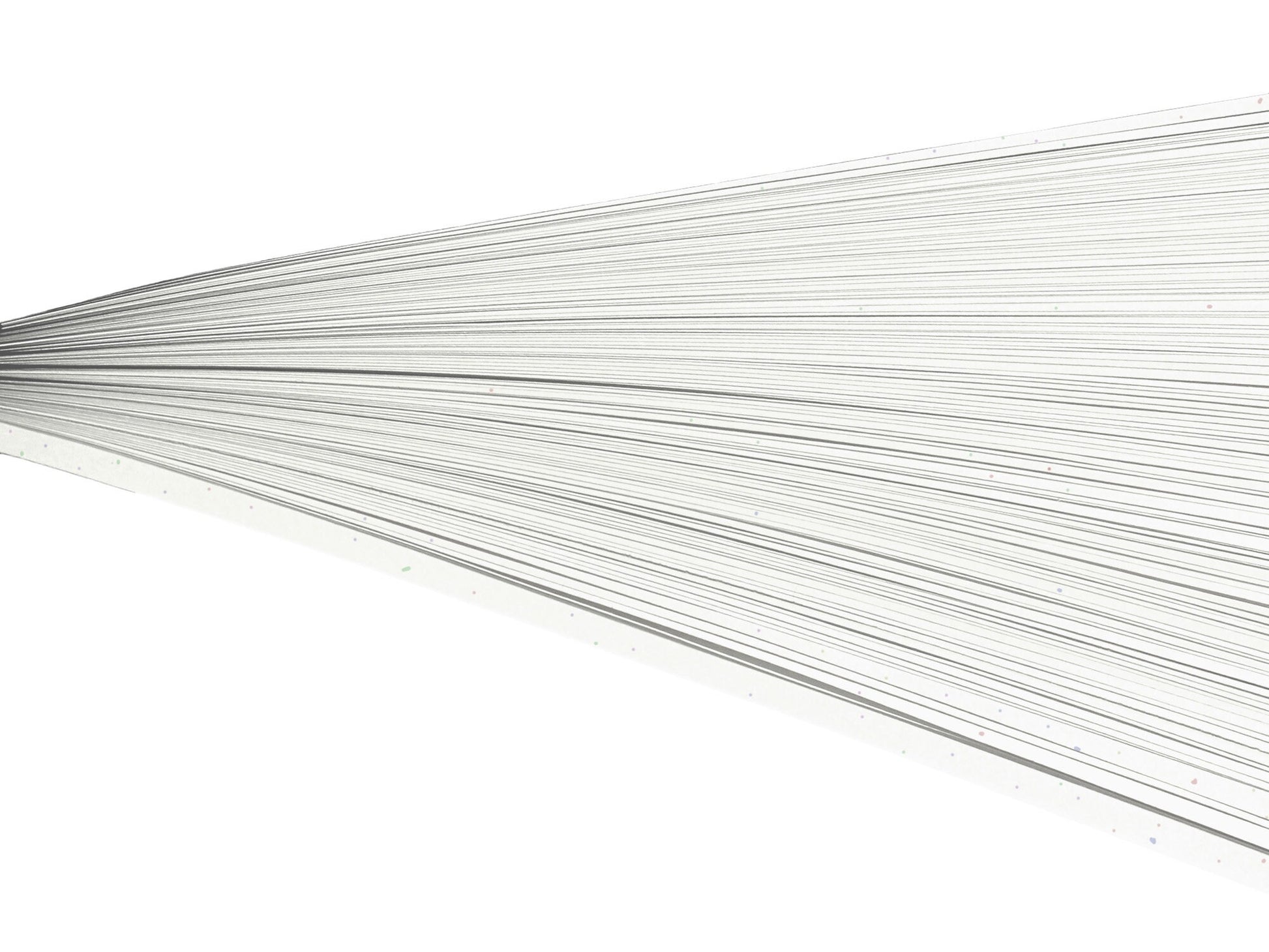 Off-white rainbow speckled paper quilling strips on their side against a white background.