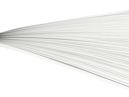 Off-white rainbow speckled paper quilling strips on their side against a white background.