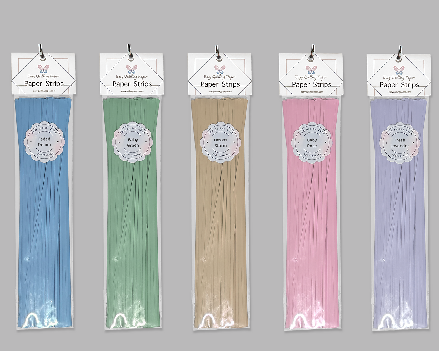 Various colors of flat quilling paper in resealable bags with hanging holes hanging side by side.